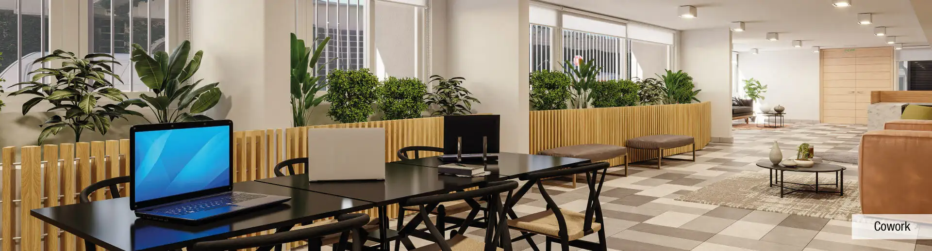 Sector Cowork de Edificio Pedro de la Barra en Santiago Centro, destacando mesas de trabajo y jardineras de interior.