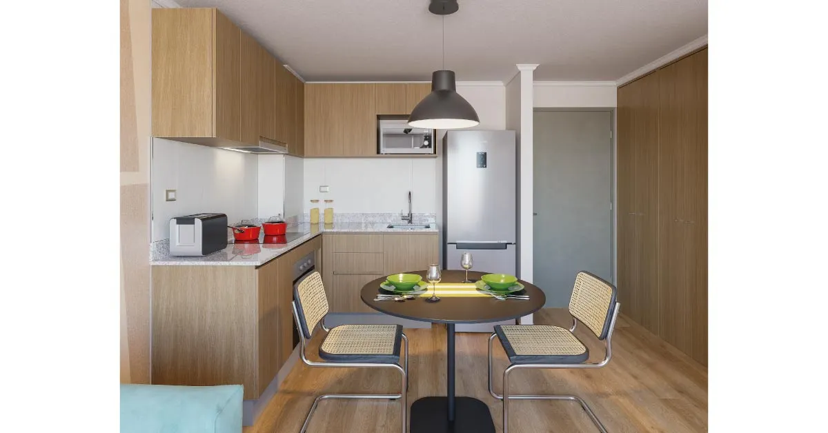 Comedor y cocina de Condominio Trocadero en Antofagasta, destacando el piso vinílico SPC y cubierta de granito.