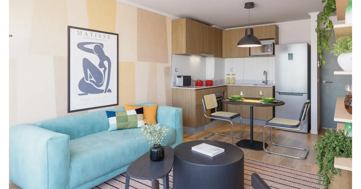 Living y cocina integrada de Condominio Trocadero en Antofagasta, destacando sus muebles con cubierta de granito.