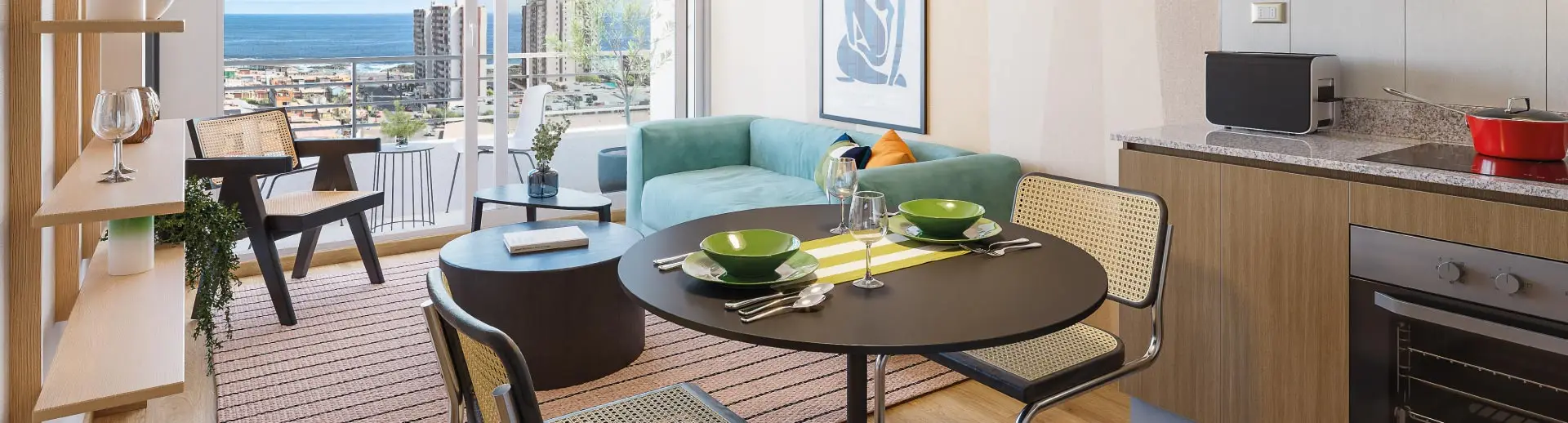 Living comedor de Condominio Trocadero en Antofagasta, destacando la cocina equipada con cubierta de granito.